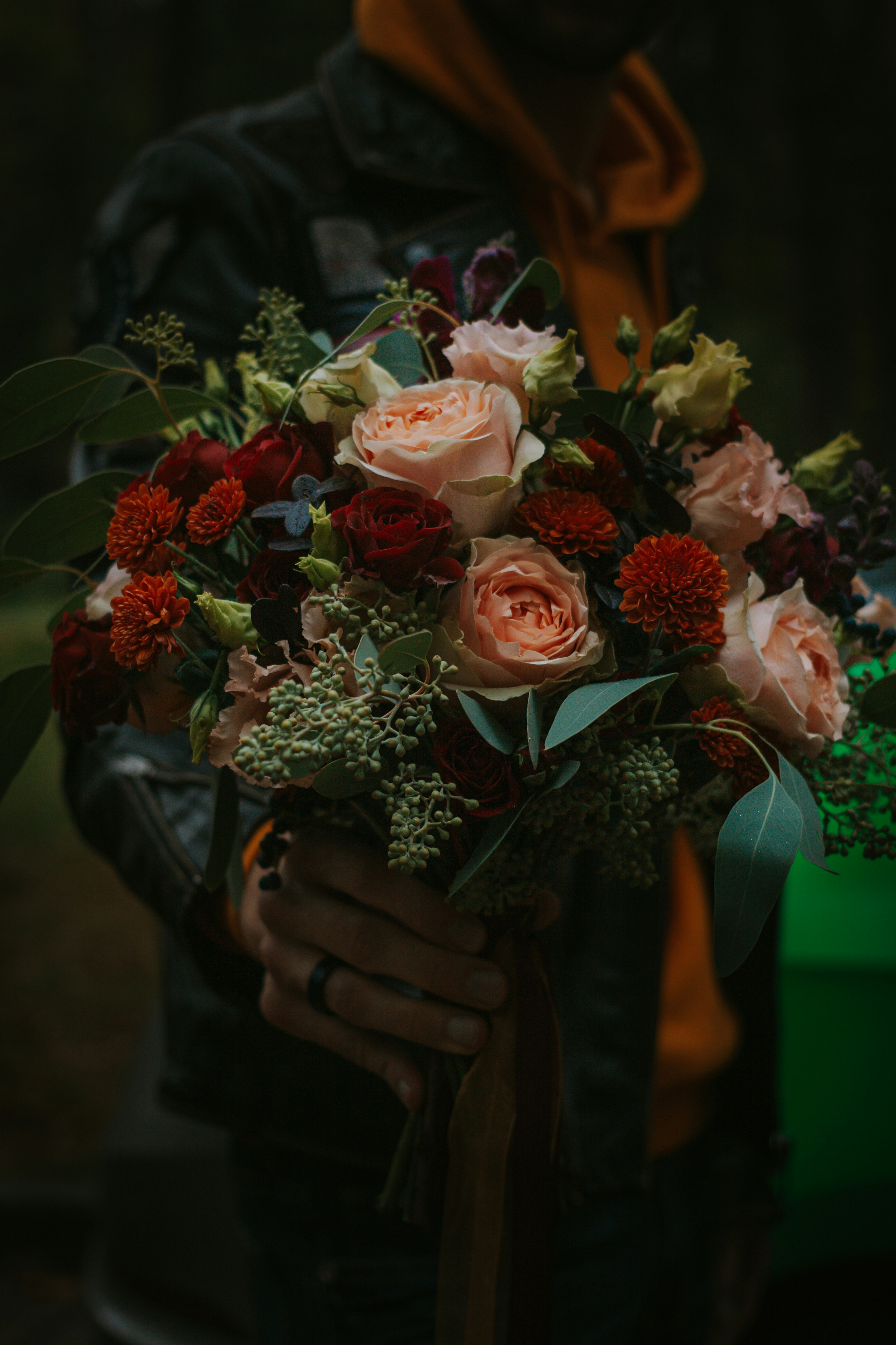 man holding red and cream flowers